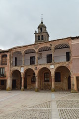 Fototapeta na wymiar Main Square With Arched Portals In The High Part View Of The Church Tower In The Village Of Medinaceli. Architecture, History, Travel. March 19, 2016. Medinaceli, Soria, Castilla Leon, Spain.