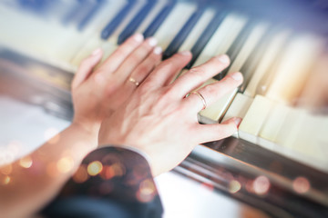 Newly wed couple's hands with wedding rings. newlyweds showing their wedding rings on piano