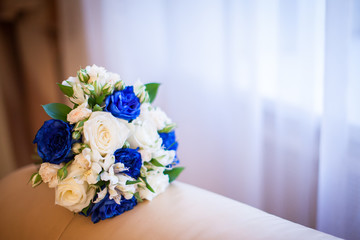 Wedding bouquet. Bride's flowers are white and blue roses