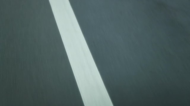 Asphalts lines on road passing by at 120fps. Abstract lines on highway road in movement2