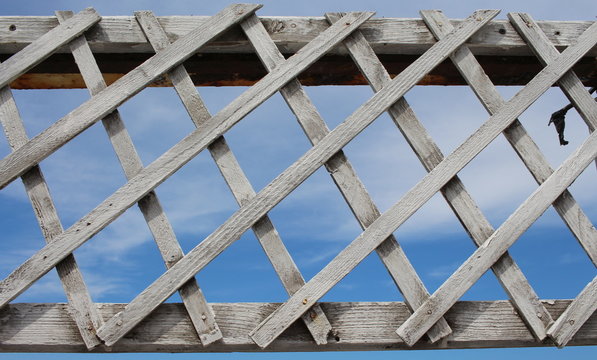 Old wooden grate against the blue sky and the sea.