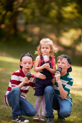 Fototapeta premium The small children eating ice creams