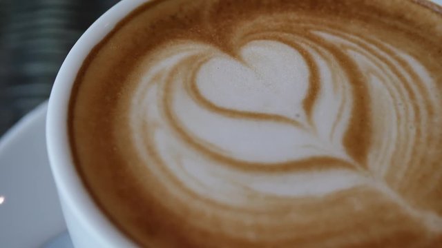 heart latte art of hot coffee drink in cup