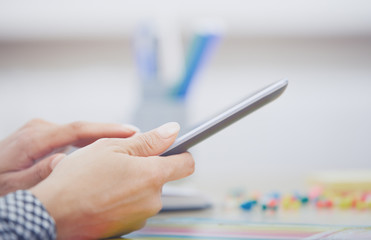 Woman using digital tablet at office