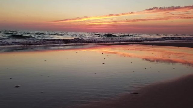 Hyperlapse of waves, sand, and sunset on the beach