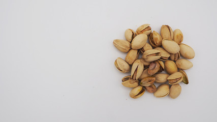Pistachios on white background.It's roasted dried green nut or shell  close up  top view healthy snack  .