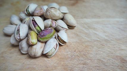 Group of pistachios on wooden.It's green nut .