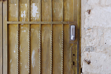 Old door with code lock and metal grid