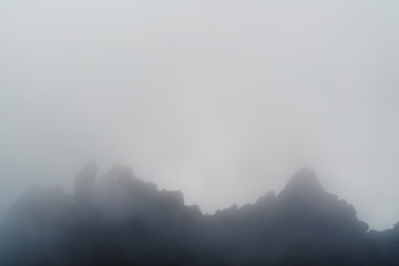 Peaks of the mountain in mist and clouds
