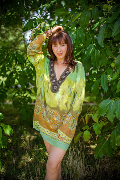 Ethnic middle age hippie woman posing in boho style clothes at nature. Outdoor fashion. Concept of boho style and etno  
