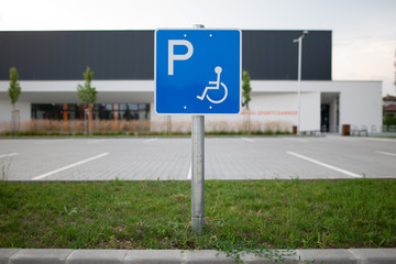 Disabled traffic sign at an empty car park represent handicap parking space without car or people