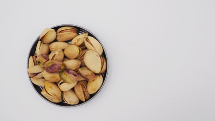 Pistachios on white background.It's roasted dried green nut or shell  close up  top view healthy snack  .