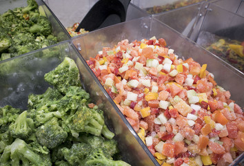 Assortment of frozen vegetables in supermarket fridge