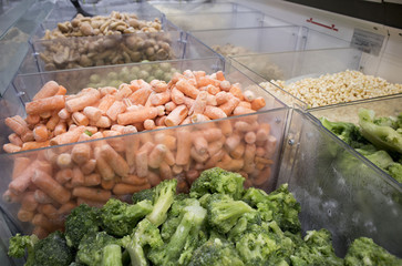 Assortment of frozen vegetables in supermarket fridge