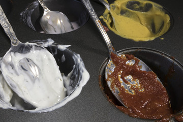 spoons smeared with sauce after a meal. spoons stained with ketchup, mayonnaise, mustard, caviar, sour cream
