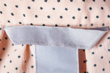 Blank Clothing label closeup on fabric texture