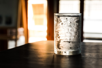 Glass of Iced cold water on the wooden table.