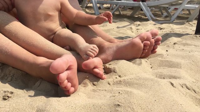Summer vacation, happy feet on the beach. Feet closeup of relaxing on beach in sunny summer day.