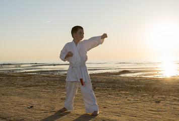 The boy in a kimono on the beach