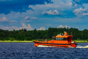 Orange pilot boat in action