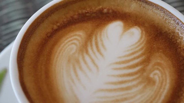 heart latte art of hot coffee drink in cup