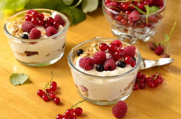 Fresh berries, yogurt and granola parfait on a wooden table
