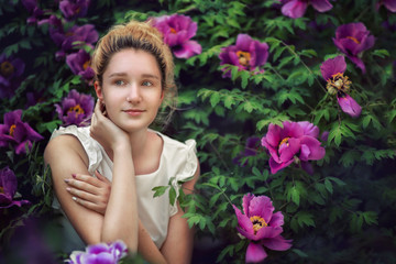 Young girl on a background of pink flowers