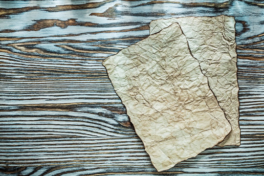 Vintage crumpled document on wooden board