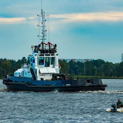 Black tug ship underway