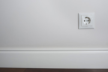 White wall with european electric outlet.