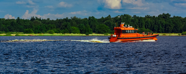 Orange pilot boat in action