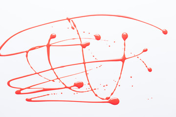 Nail polish on a white background in the form of strips and drops