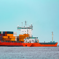 Red container ship underway