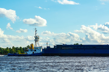 Blue tug ship underway