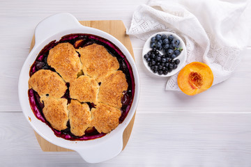 Freshly baked peach and blueberry cobbler. Homemade fruit pie.