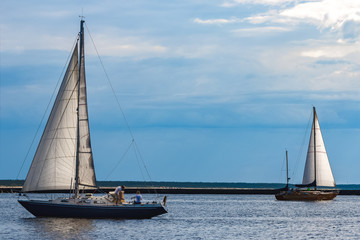 Fototapeta premium Blue sailboat at river