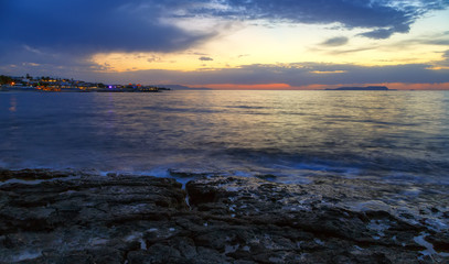 Fototapeta premium Nature in twilight period which including of sunrise over the sea and the nice beach. Summer beach with blue water and purple sky at the sunset.
