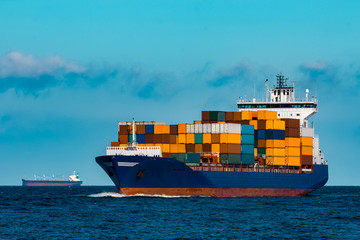 Blue container ship underway