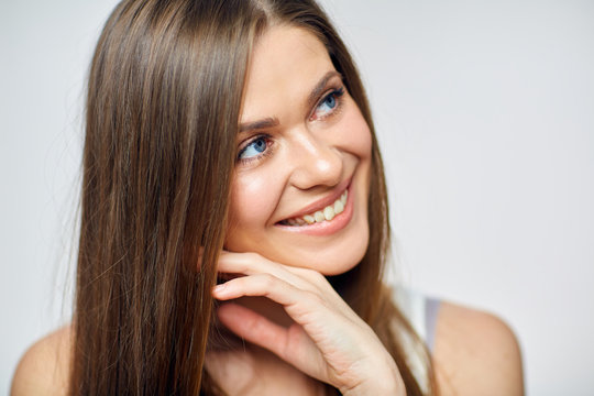 Beautiful smiling woman looking side. Close up face portrait.
