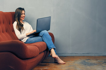 Woman working with laptop at home.