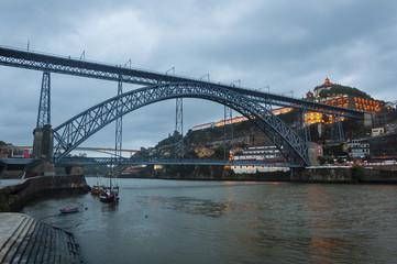 View of the Douro River and the iconic Dom Luis Bridge from the Ribeira neighbourhood in Porto, Portugal