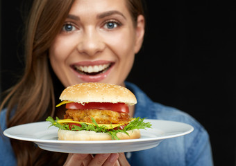 Close up face portrait of smiling woman holding burger on white