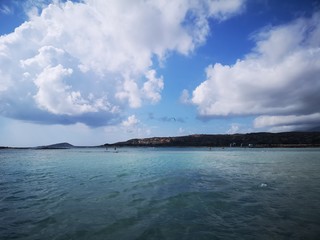 Beautiful beach near mountains covered with clouds