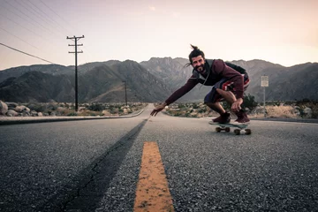 Tuinposter downhill skateboarding in the mountains in america © Alexander