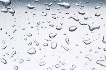 Drops of water on a gray background closeup