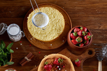 Delicious cake with fresh organic strawberries and mint, top view, close-up, selctive focus.