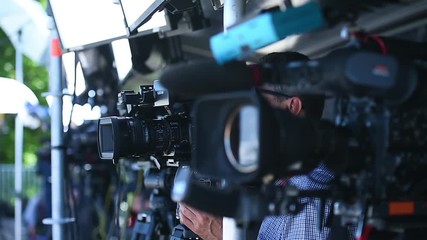 Television cameras in a row broadcasting a live media event