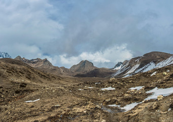 Mountain landscape with snow on the trail and white clouds, Nepal.