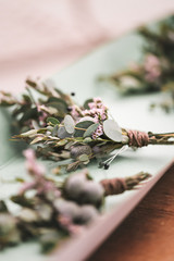 Boutonniere with light pink flowers and eucalyptus