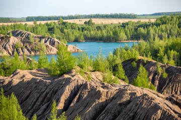 Image of hilly terrain with green trees and river